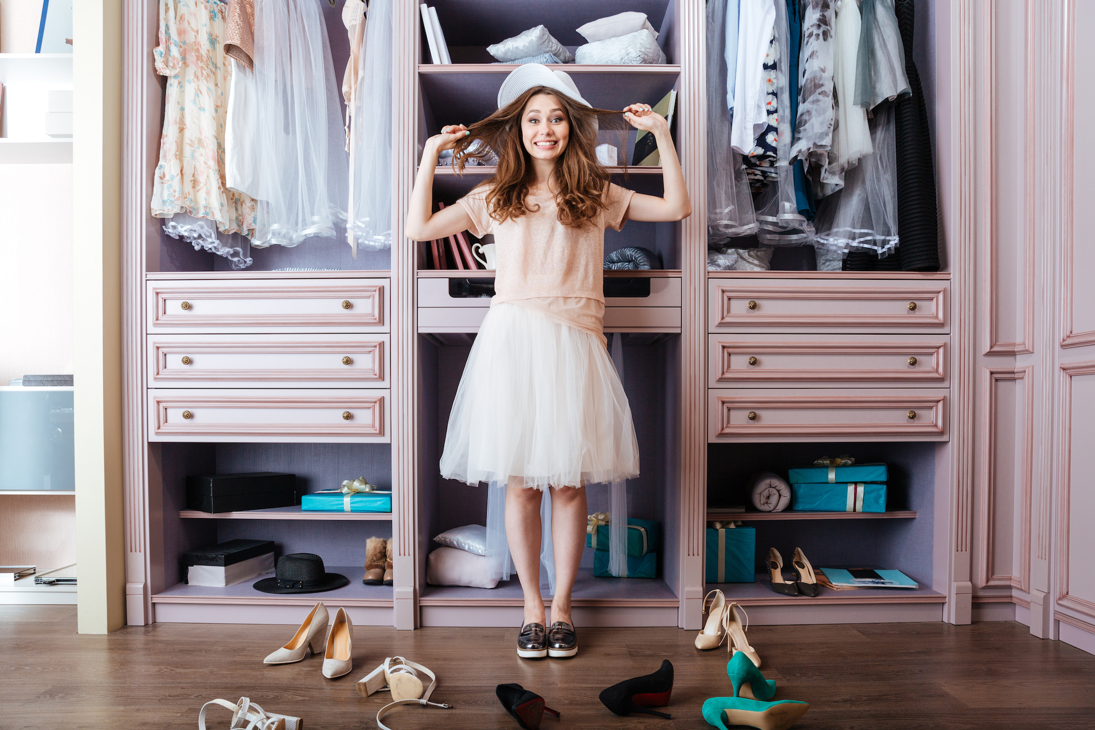 Girl standing in front of wardrobe deciding which shoes to wear