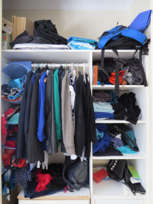 Messy, disorganised clothes in wardrobe before Your Wardrobe Audit in 5 Easy Steps