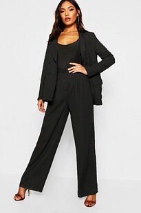 Black palazzo pants teamed with a black top and high heels makes the wearer look taller and slimmer 