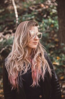 Girl wears rose beige coloured glasses to match her hair colour.