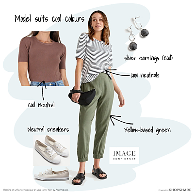 Woman wears a casual outfit of khaki coloured pants, a striped tee shirt, sneakers and silver earrings.