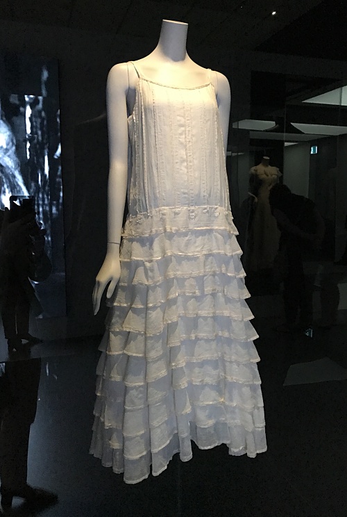 Photo of a white Chanel dress made from cotton chiffon. It has spaghetti straps and eleven ruffled tiers from hip level down.