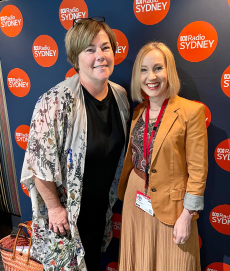 Two women stand in front of an ABC Radio Sydney sign. The lady on the left is Toni Matthews; radio presenter and interviewer. The woman on the right is Ann Vodicka, a colour analysis expert based in Sydney.