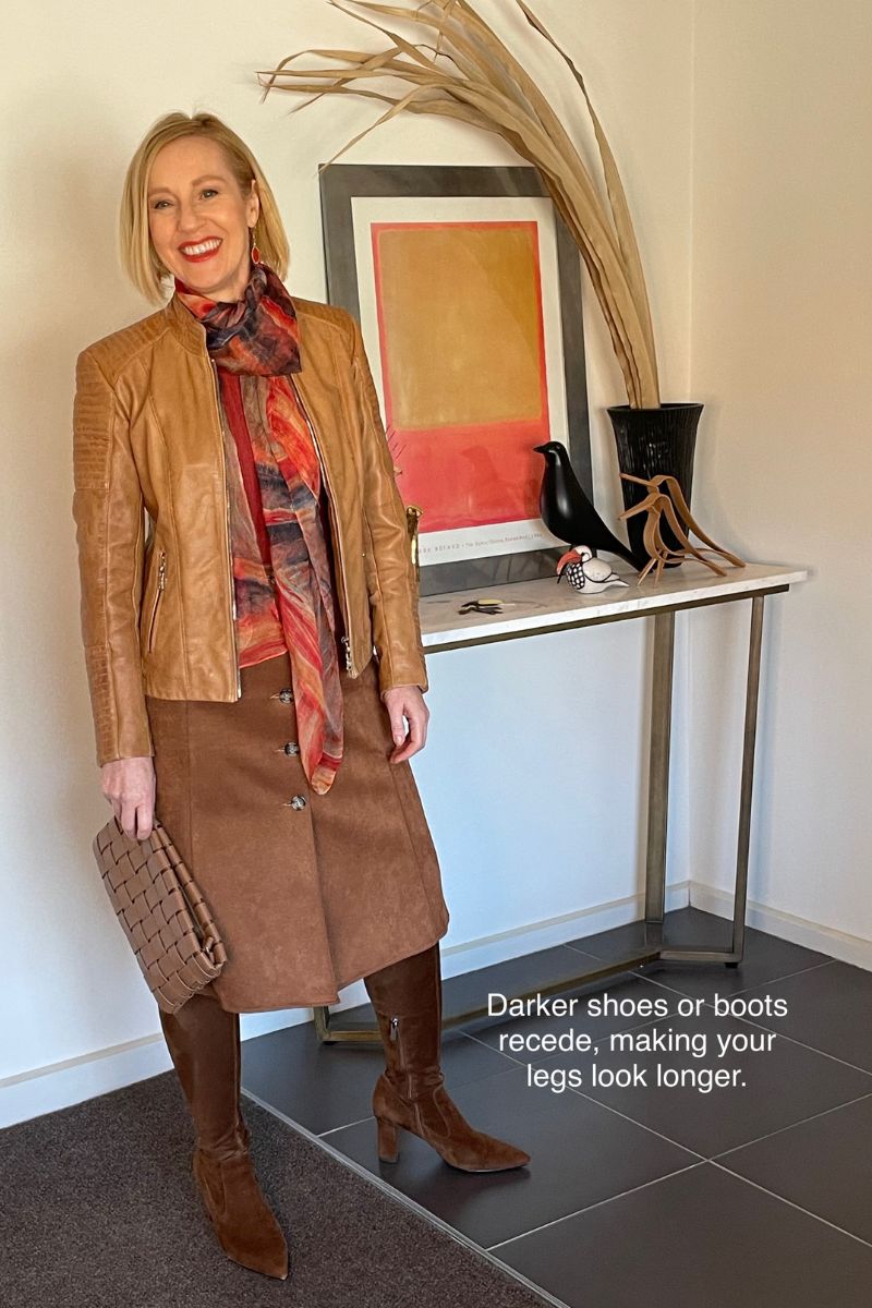 Style tip: matching a brown skirt with darker brown boots for a leg-lengthening effect.